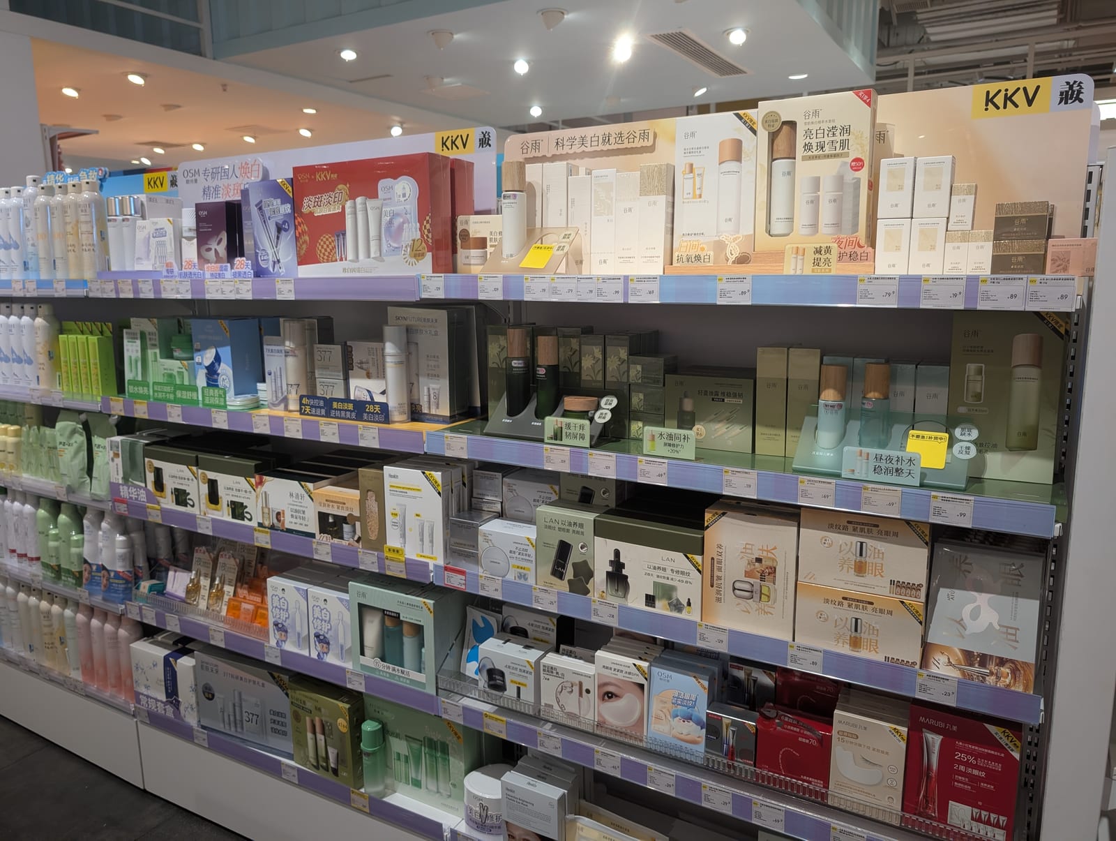 Shelves of domestic Chinese skincare products including serums, creams, and sheet masks