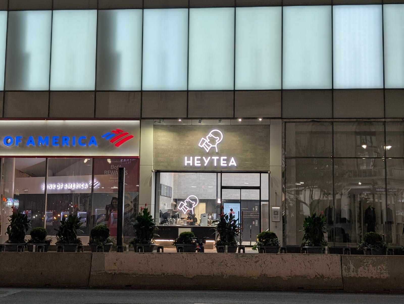 A HEYTEA storefront in New York at night, next to a Bank of America branch